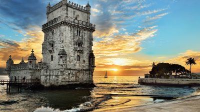 Belem Tower with a small boat at a beautiful sunset,  Lisbon.